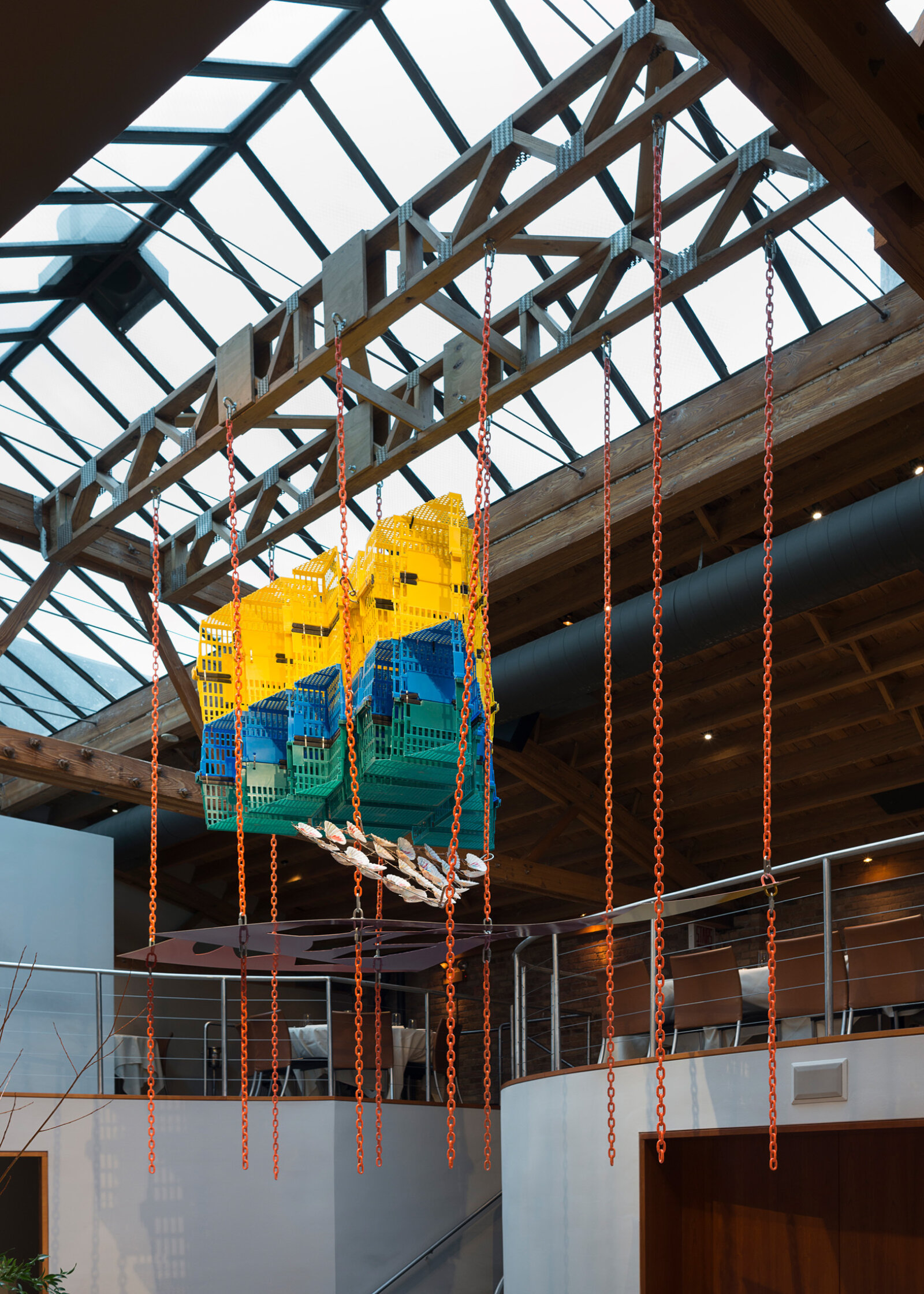Jessica Stockholder, Another Piece of Pie, 2015, plastic shopping baskets, metal plate, paint, chains, hardware, metal rod, scallop shells, 144 x 132 x 72 in. (366 x 335 x 183 cm). Installation view, MN Restaurant, Chicago, USA