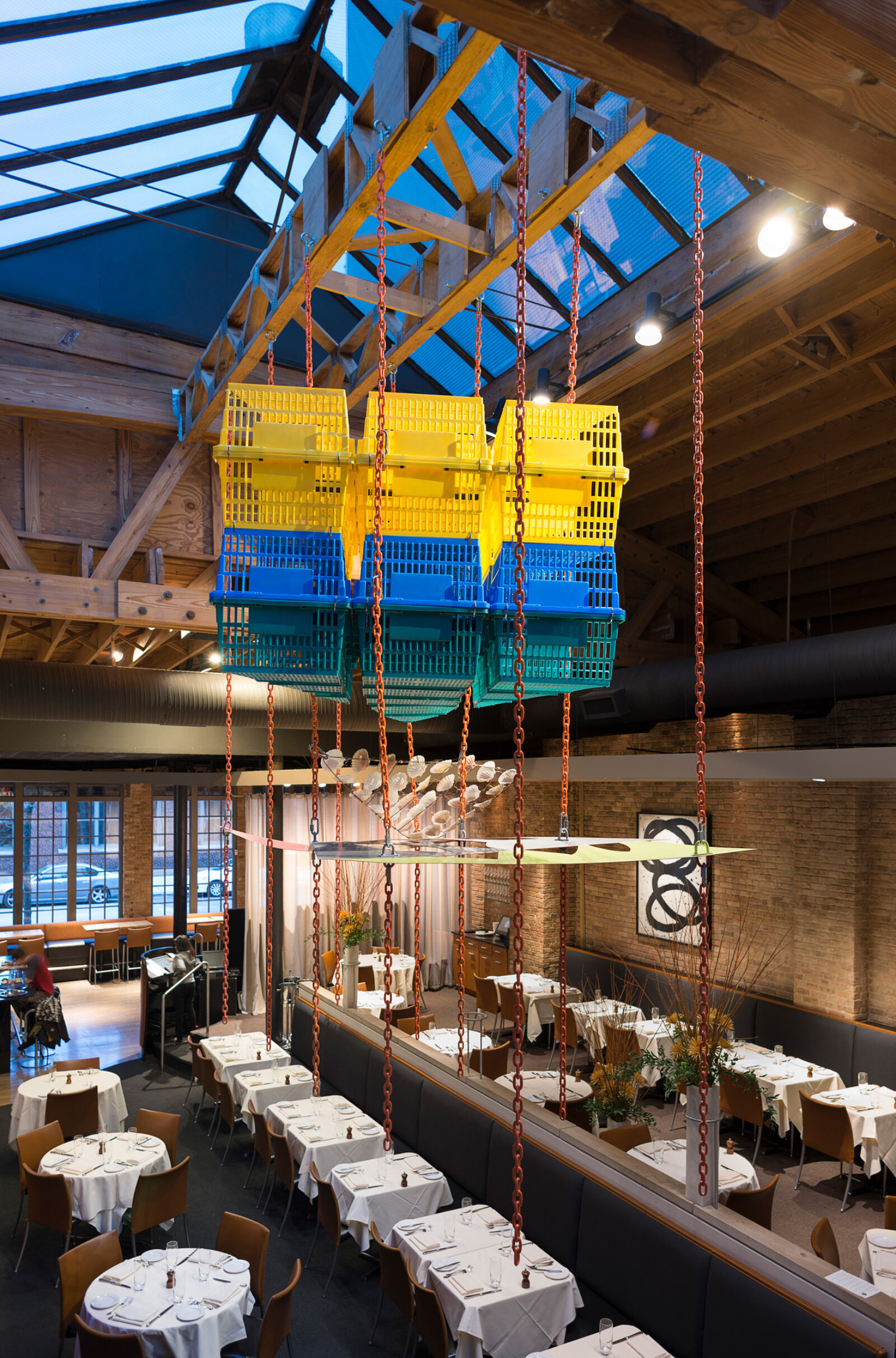 Jessica Stockholder, Another Piece of Pie, 2015, plastic shopping baskets, metal plate, paint, chains, hardware, metal rod, scallop shells, 144 x 132 x 72 in. (366 x 335 x 183 cm). Installation view, MN Restaurant, Chicago, USA
