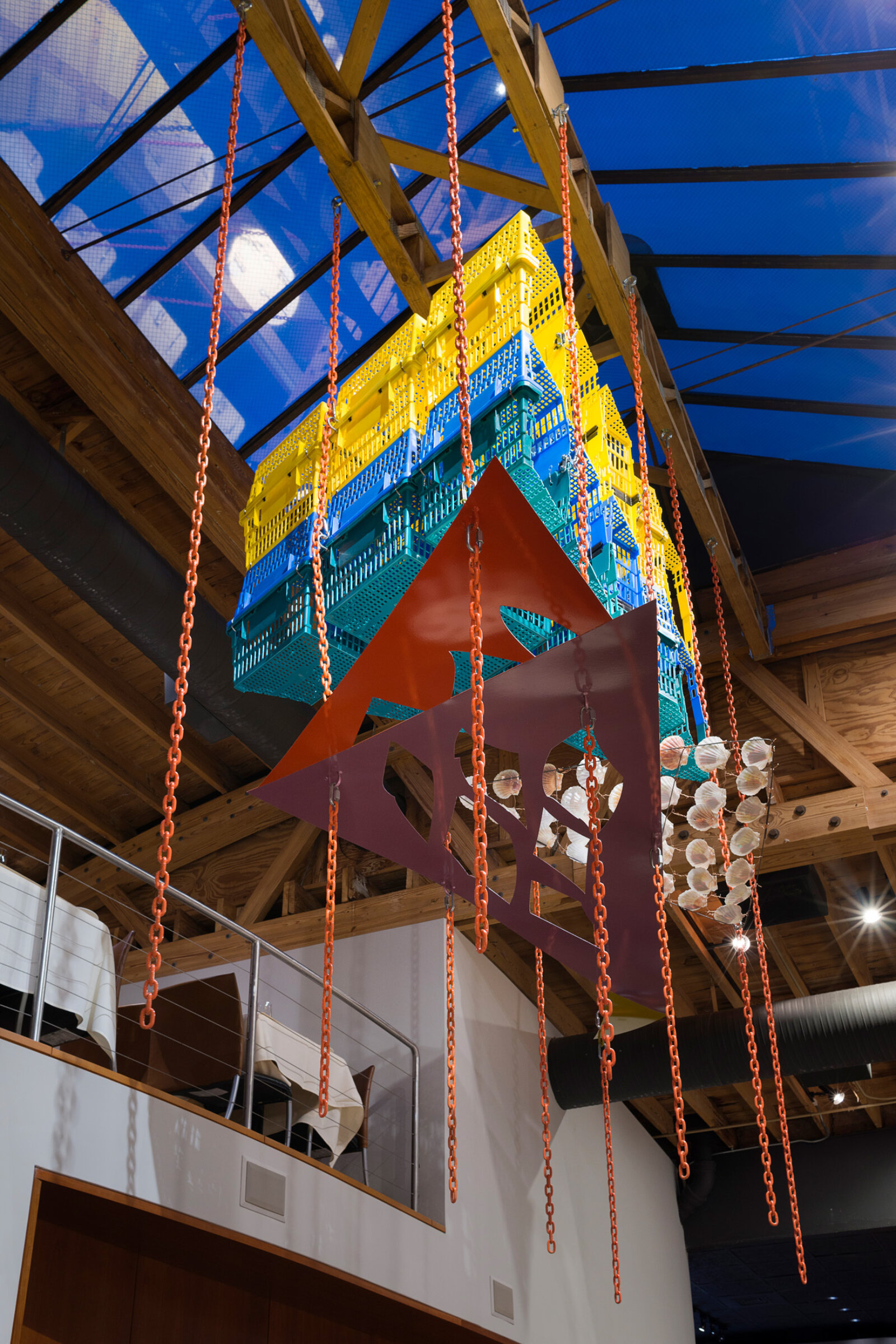 Jessica Stockholder, Another Piece of Pie, 2015, plastic shopping baskets, metal plate, paint, chains, hardware, metal rod, scallop shells, 144 x 132 x 72 in. (366 x 335 x 183 cm). Installation view, MN Restaurant, Chicago, USA