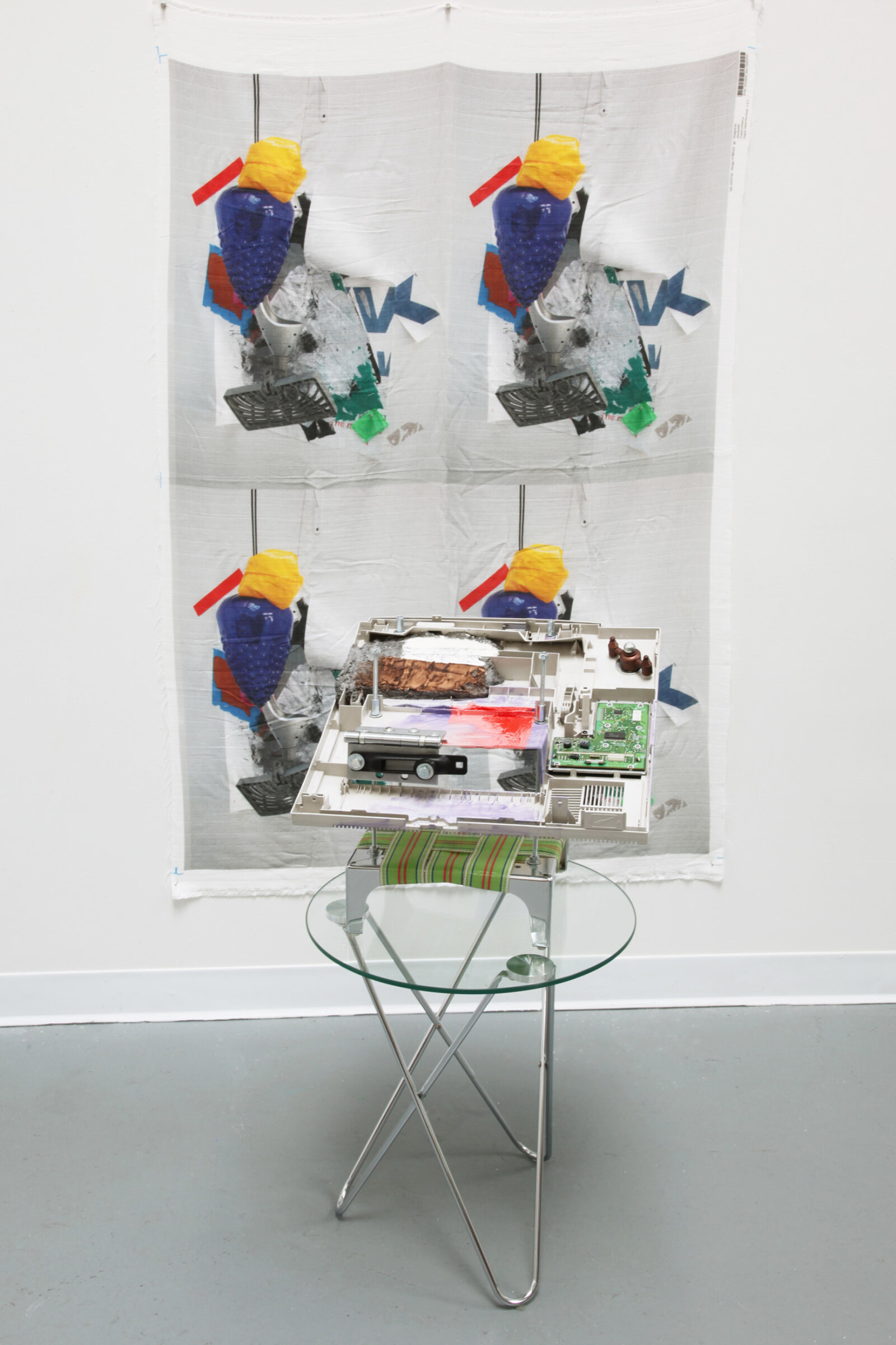 Jessica Stockholder, Behind the wallpaper, 2020, plastic printer part, hardware, paper maché, acrylic and oil paint, nylon webbing, metal base, photo printed on fabric, 16 x 17 x 17 in. (41 x 43 x 42 cm), 62 x 39 in. (158 x 99 cm)