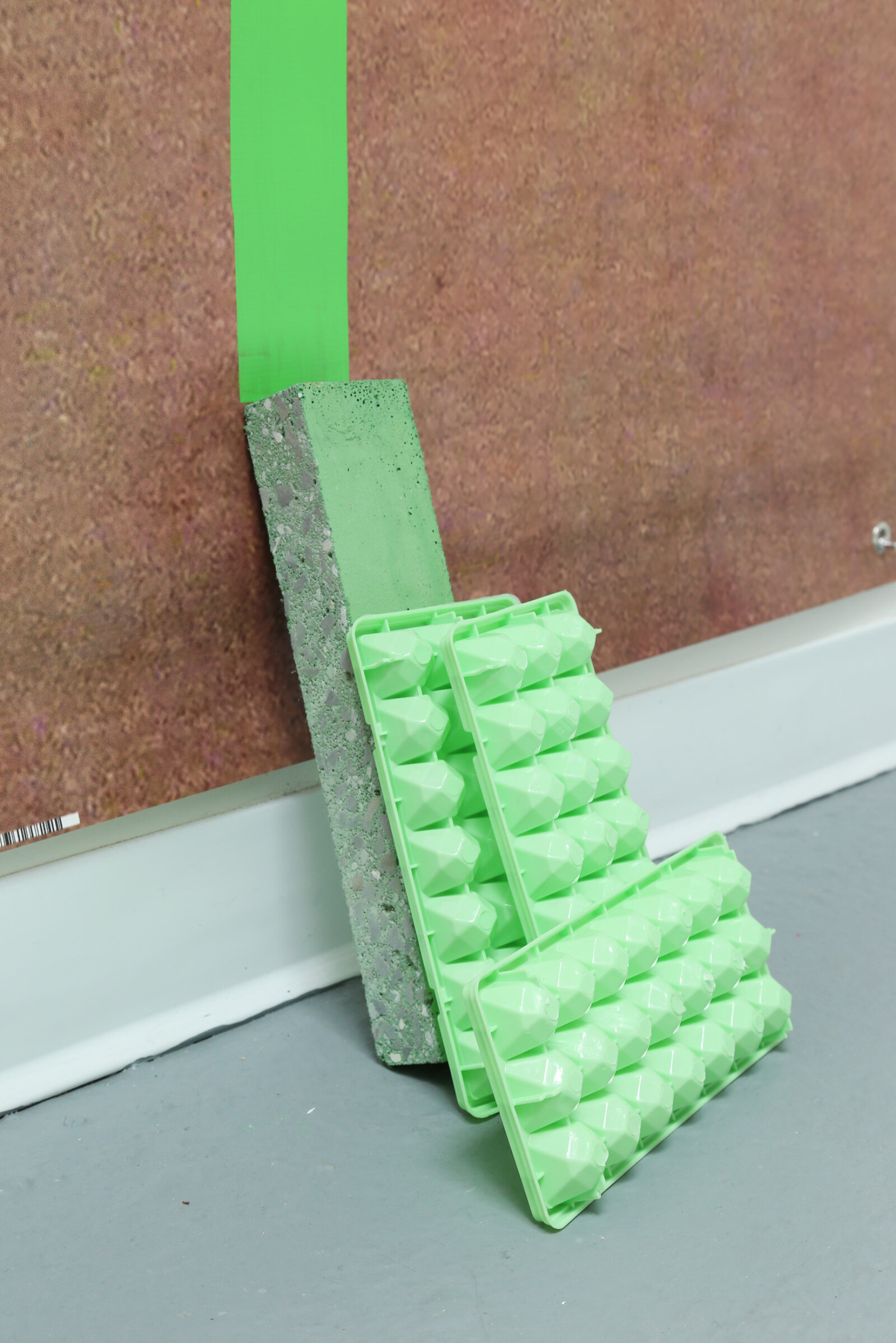 Jessica Stockholder, Cracks Belly (detail), 2015, 4 printed photo banners with grommets, TV stand, plastic parts, expanded foam, ice trays, concrete, string, plastic tube, hardware, acrylic paint, 110 x 124 x 25 in. (278 x 315 x 62 cm)