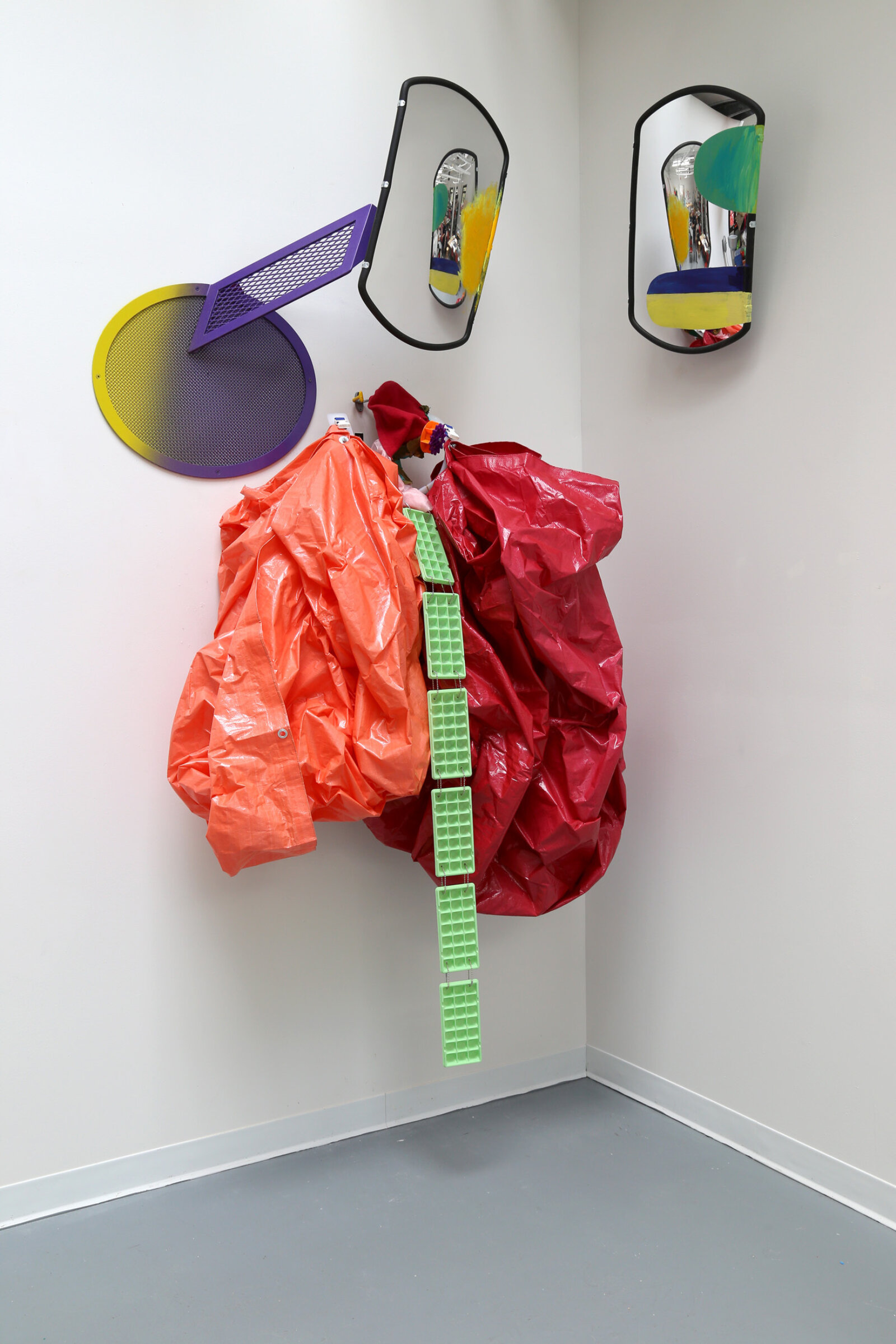 Jessica Stockholder, Curtsy in the Blind, 2015, 2 driveway mirrors, custom hardware, 2 tarps, ice trays, plastic parts, fabric, acrylic paint, 110 x 60 x 24 in. (279 x 152 x 61 cm)