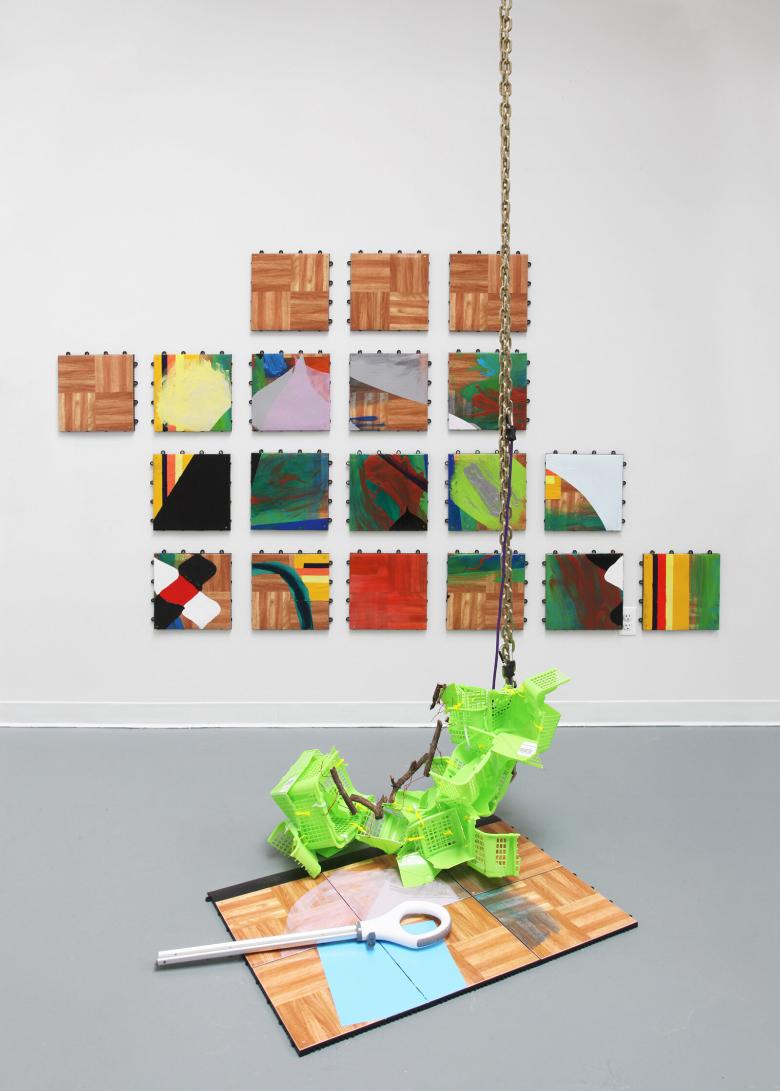 Jessica Stockholder, Floored, 2015, dance floor panels, acrylic paint, broken plastic baskets, sticks, wire, chain, bungee cord, vacuum cleaner handle, 75 x 103 x 69 in. (191 x 262 x 175 cm)