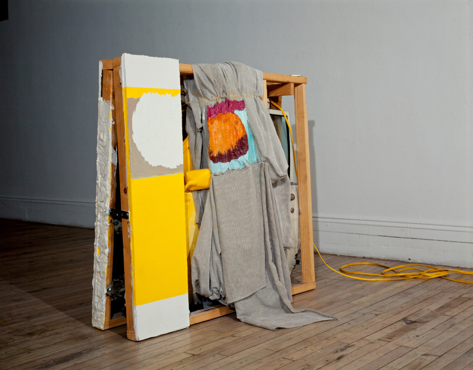 Jessica Stockholder, JS114, 1989, car door, sheetrock, cloth, oil, acrylic and latex paint, orange light, extension cord, wood, hardware