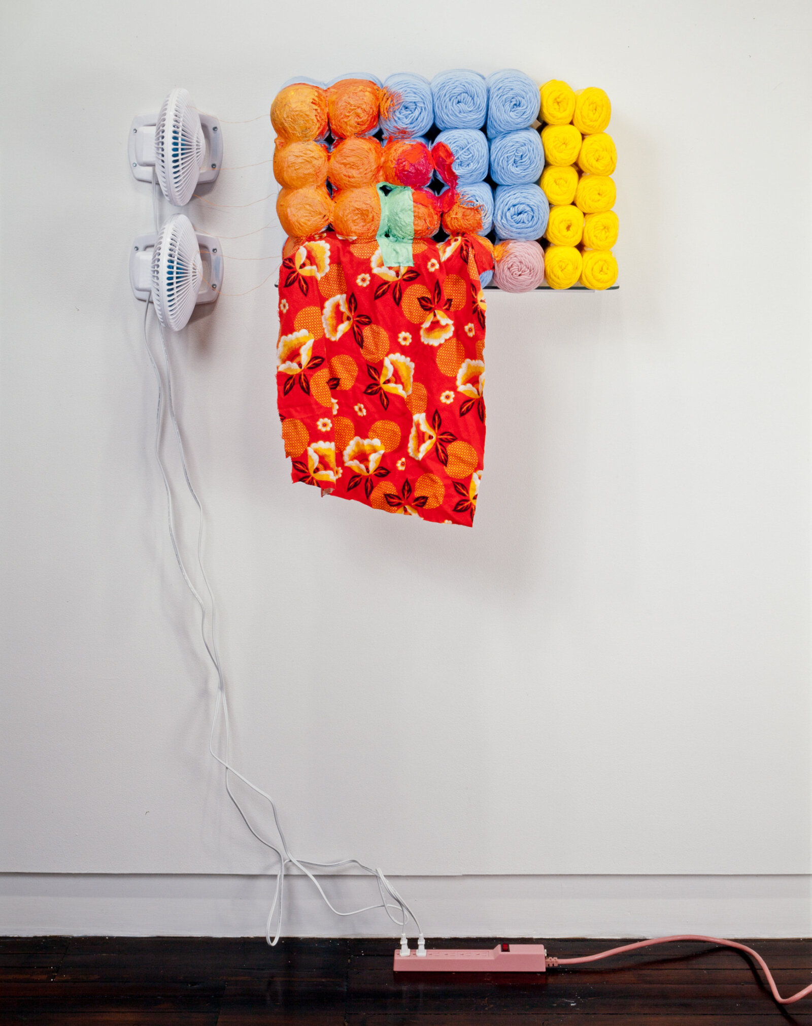 Jessica Stockholder, JS247, 1994, 2 fans, power bar, skeins of acrylic yarn, flannel cloth, silicone caulking, acrylic paint, thread, glass shelf, 64 x 32 x 10 in. (163 x 81 x 25 cm)