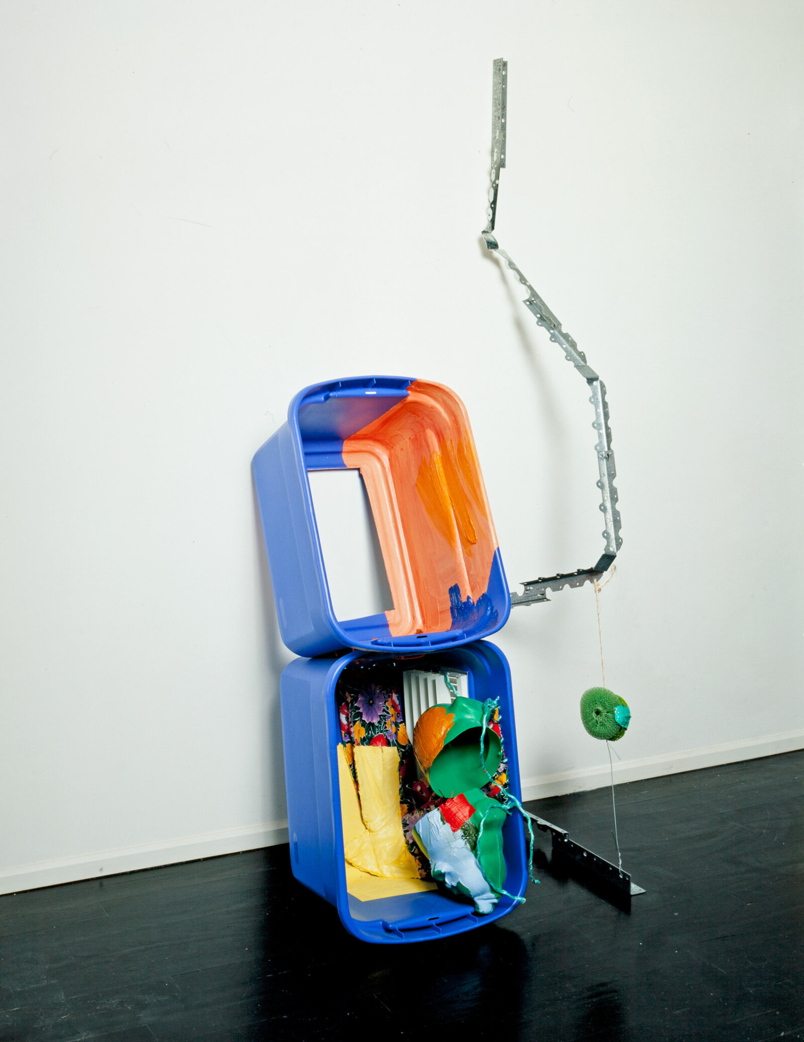 Jessica Stockholder, JS279, 1996, plastic tubs, plastic piggy bank, flowery fabric, oil paint, string, rope, wire, metal brackets, dish scrub, plastic, heating vent, 56 x 27 x 21 in. (142 x 67 x 53 cm)