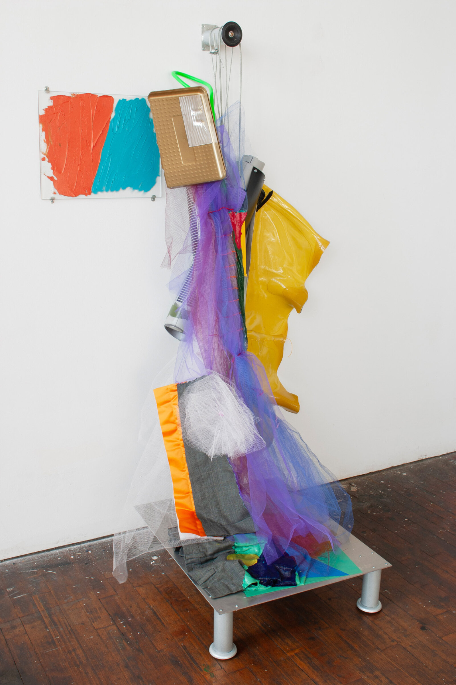 Jessica Stockholder, JS430, 2006, glass, hardware, plastic parts, rubber boots, tulle, men’s suit fabric, plastic fragments, extension cord, acrylic and oil paint, metal cable, hardware, aluminum sheet metal, 66 x 38 x 31 in. (166 x 97 x 79 cm)