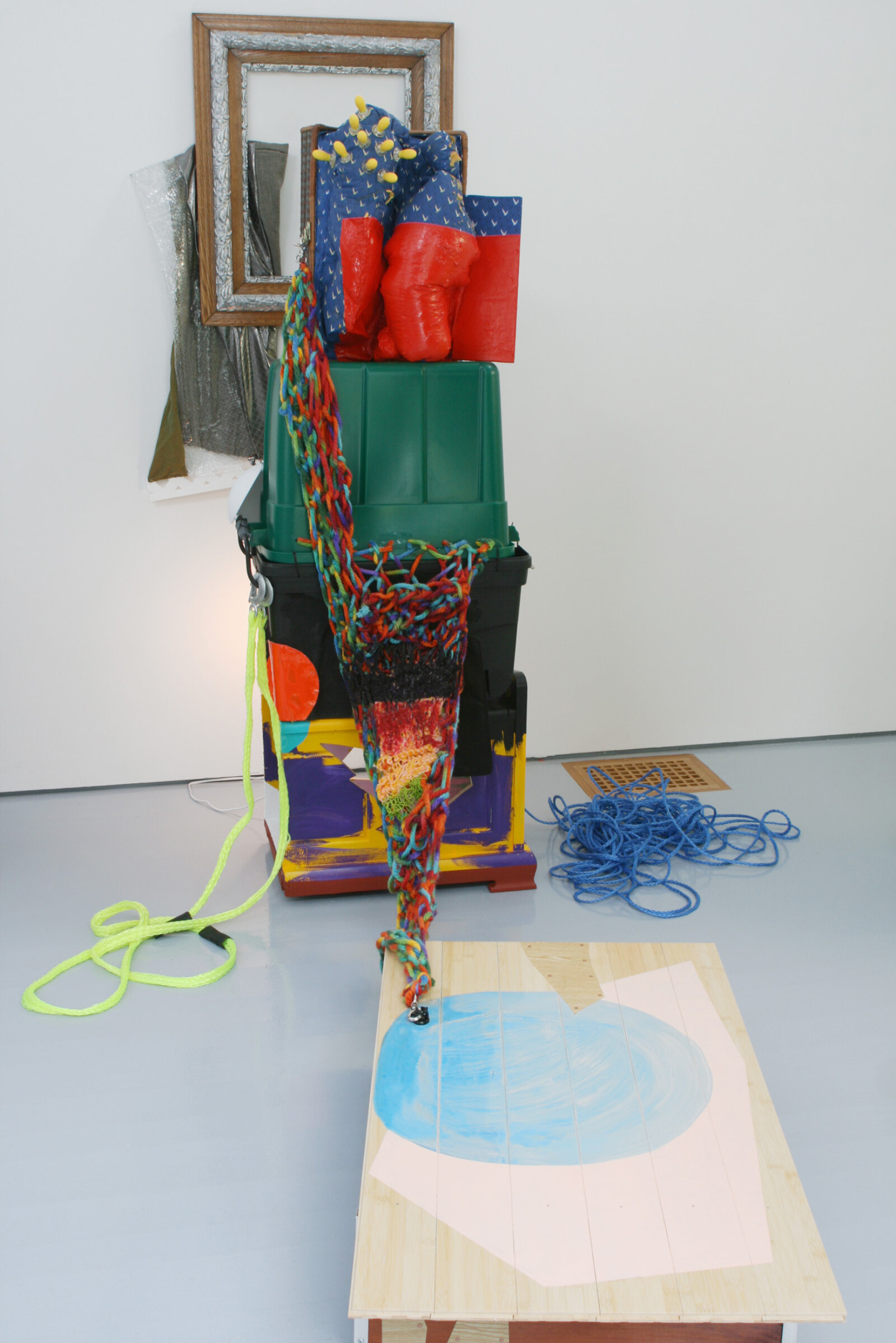 Jessica Stockholder, JS489, 2009, wooden furniture, bamboo flooring, contact paper, hardware, yarn, acrylic and oil paint, plastic tubes, rope, light fixture, frame, fabric, plastic parts, corn handles, refrigerator bulb, 105 x 79 x 64 in. (267 x 199 x 163 cm)