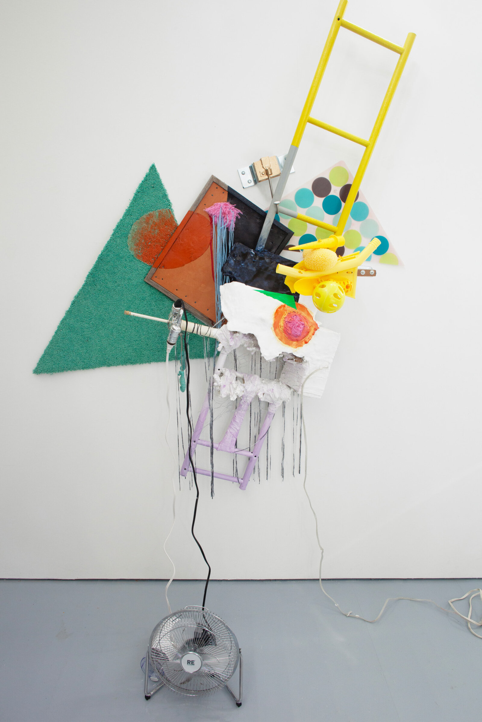 Jessica Stockholder, JS501, 2010, carpet, framed leather, yarn, plastic parts, placemat, shelving unit part, hardware, plaster, fabric, push pins, acrylic paint, coffee grinder, fan, lighting fixture, 80 x 56 x 24 in. (203 x 142 x 61 cm)