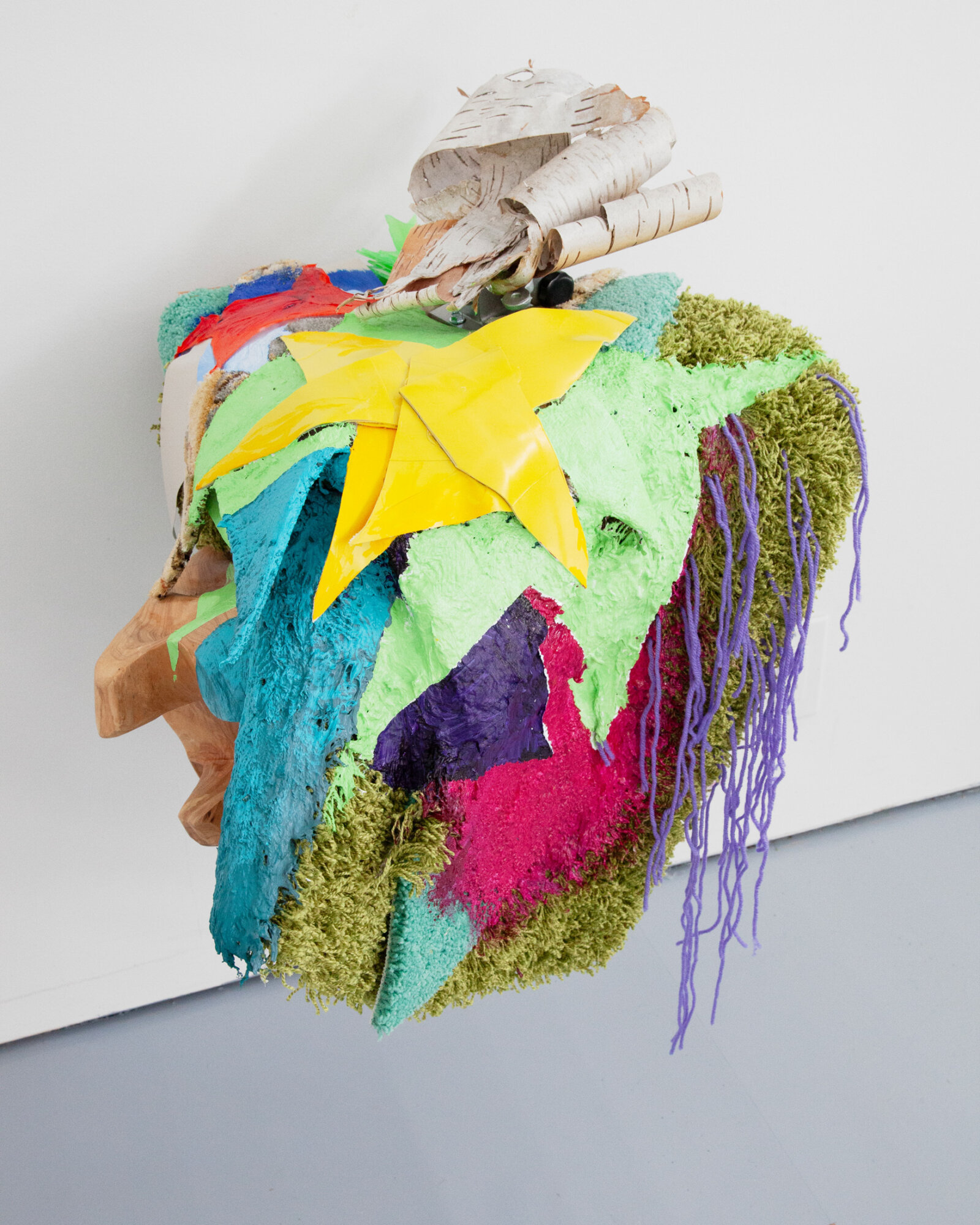 Jessica Stockholder, JS509, 2010, carpet, metal hardware, birch bark, yellow boot rubber, acrylic paint, plastic parts, yarn, wooden bowl, 29 x 21 x 23 in. (74 x 53 x 58 cm)