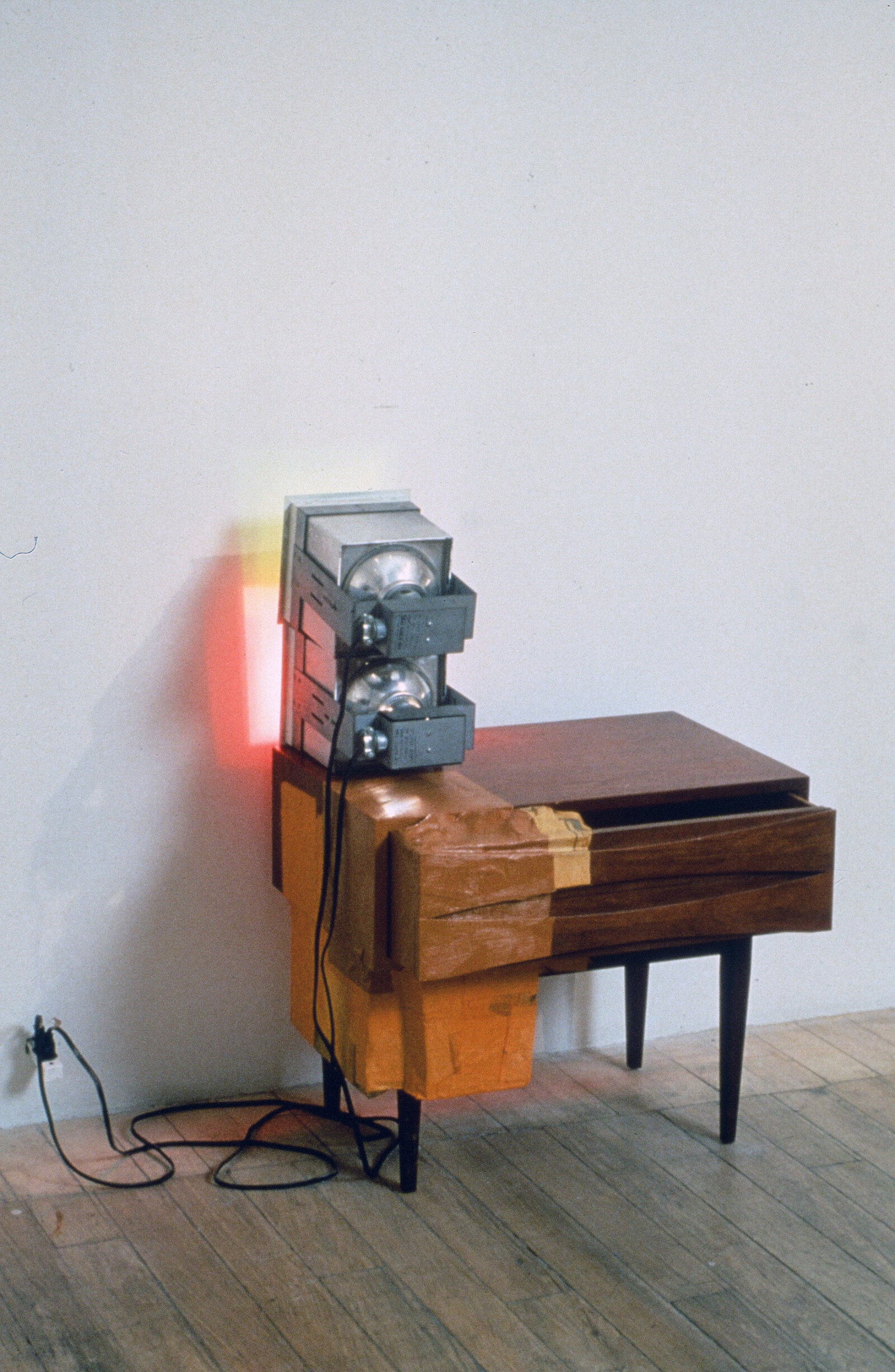 Jessica Stockholder, Kissing the Wall #4 (Red and Green), 1988, furniture, red and green lights, paint, newspaper, styrofoam