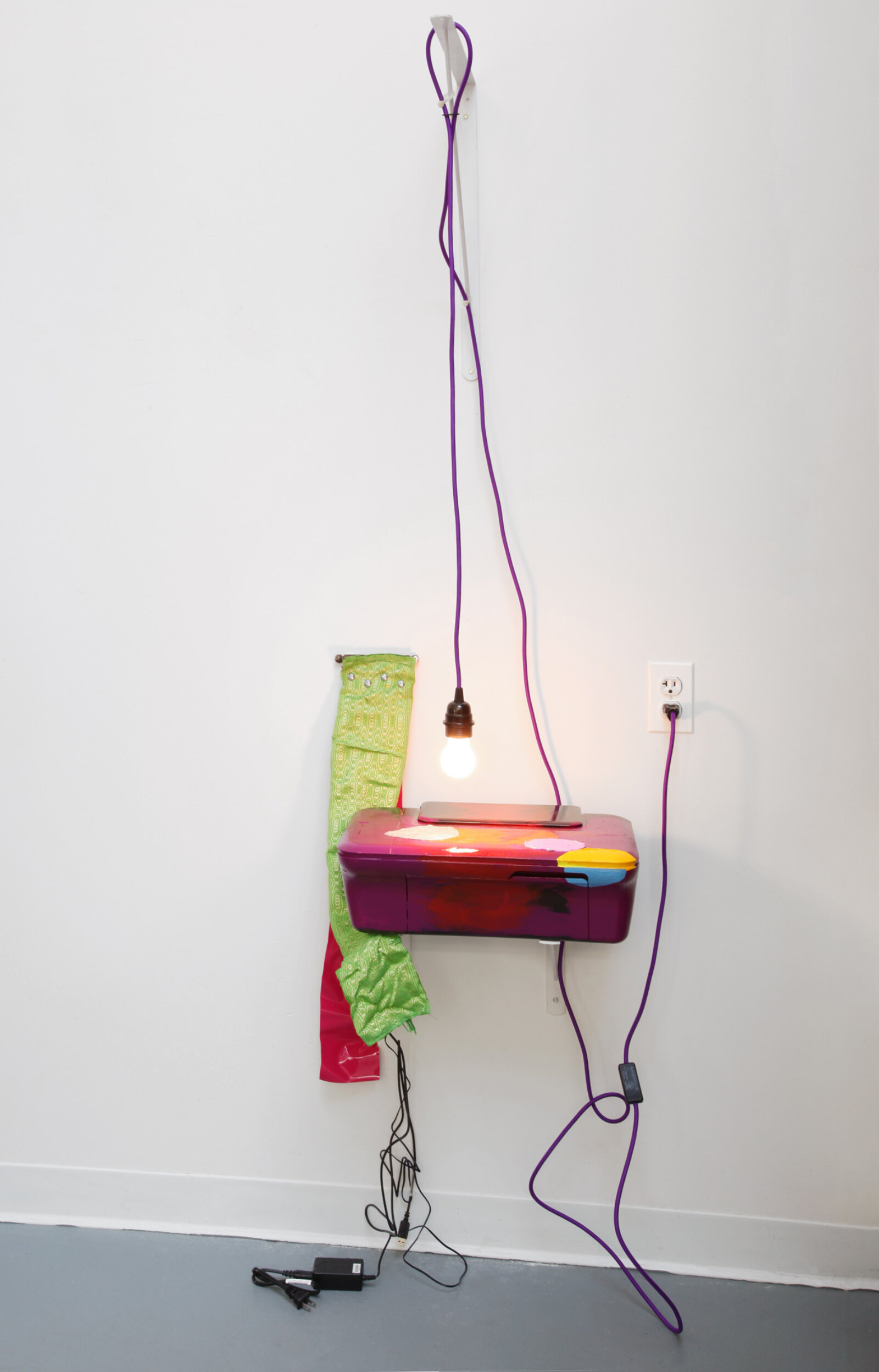 Jessica Stockholder, Longingly Slugged, 2016, printer, light bulb, light fixture, extension cord, fabric, vinyl, steel brackets, hinge, hardware, 76 x 19 x 15 in. (192 x 48 x 38 cm)