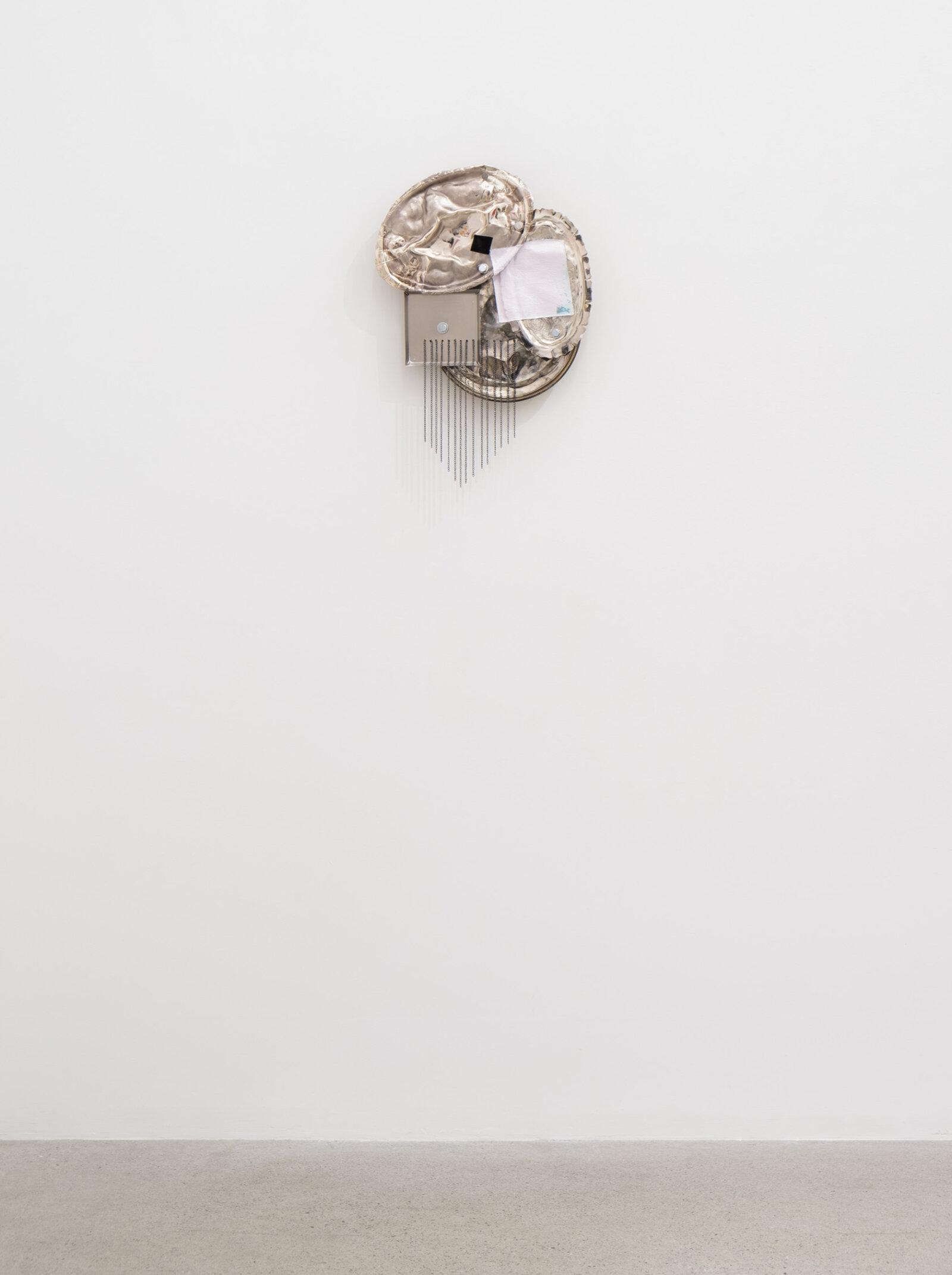 Jessica Stockholder, Origin of the World, 2026, metal trays, hardware, acrylic paint, chain, 20 x 14 x 4 in. (51 x 36 x 9 cm)