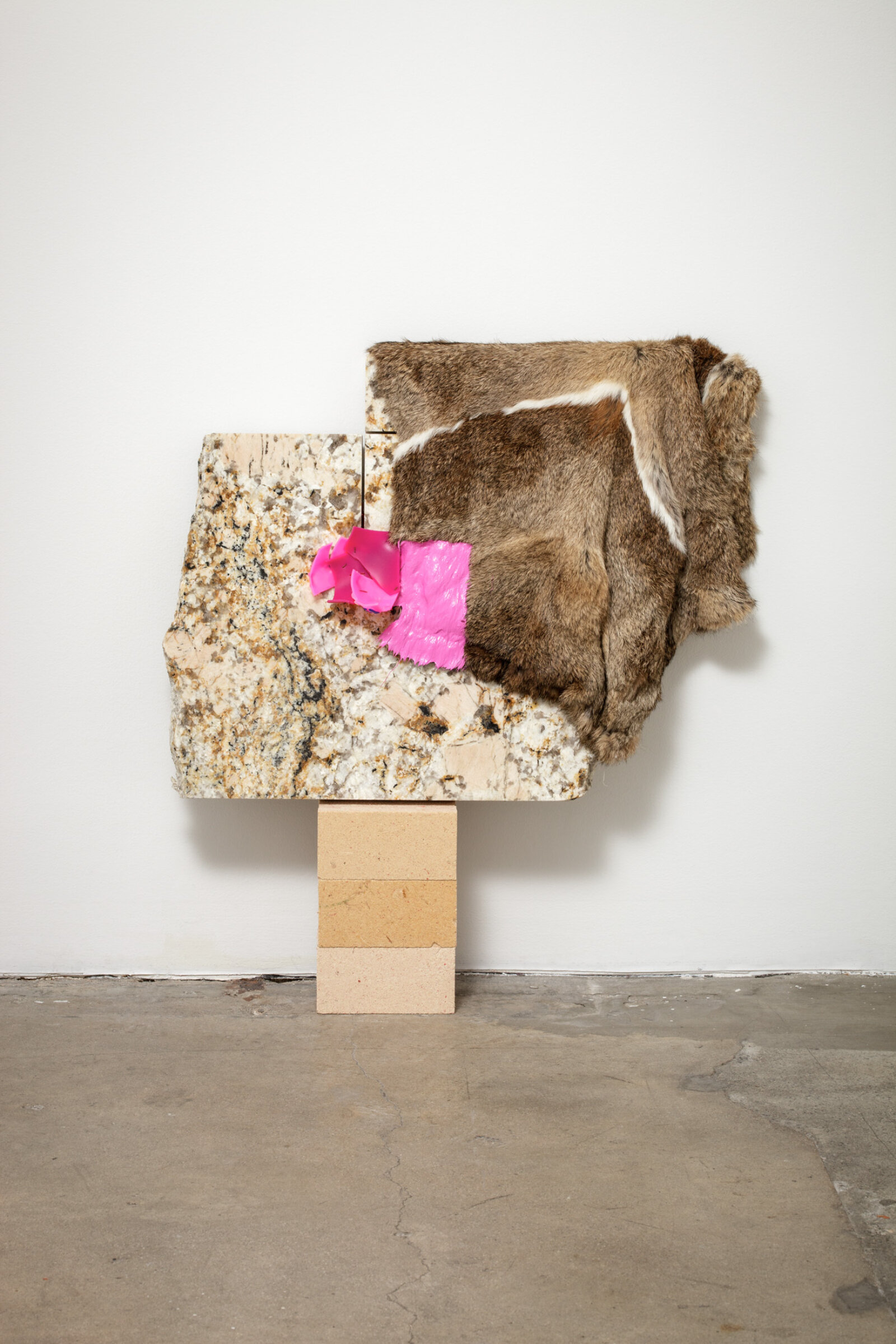 Jessica Stockholder, Related, 2013, fur, plastic parts, wood fibre blocks, granite, acrylic paint, 29 x 27 x 5 in. (72 x 69 x 13 cm)