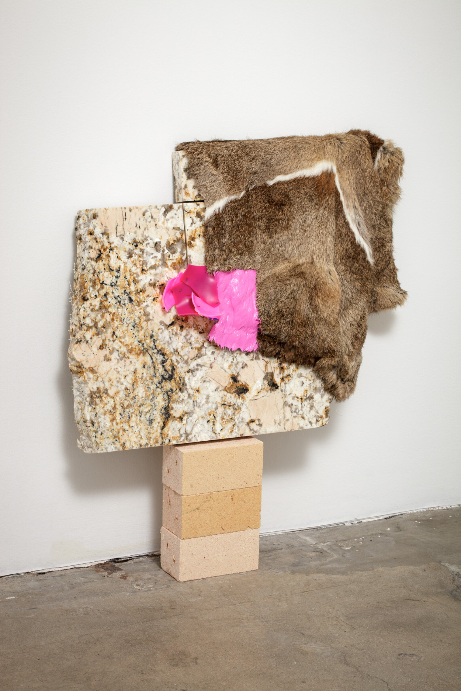 Jessica Stockholder, Related, 2013, fur, plastic parts, wood fibre blocks, granite, acrylic paint, 29 x 27 x 5 in. (72 x 69 x 13 cm)