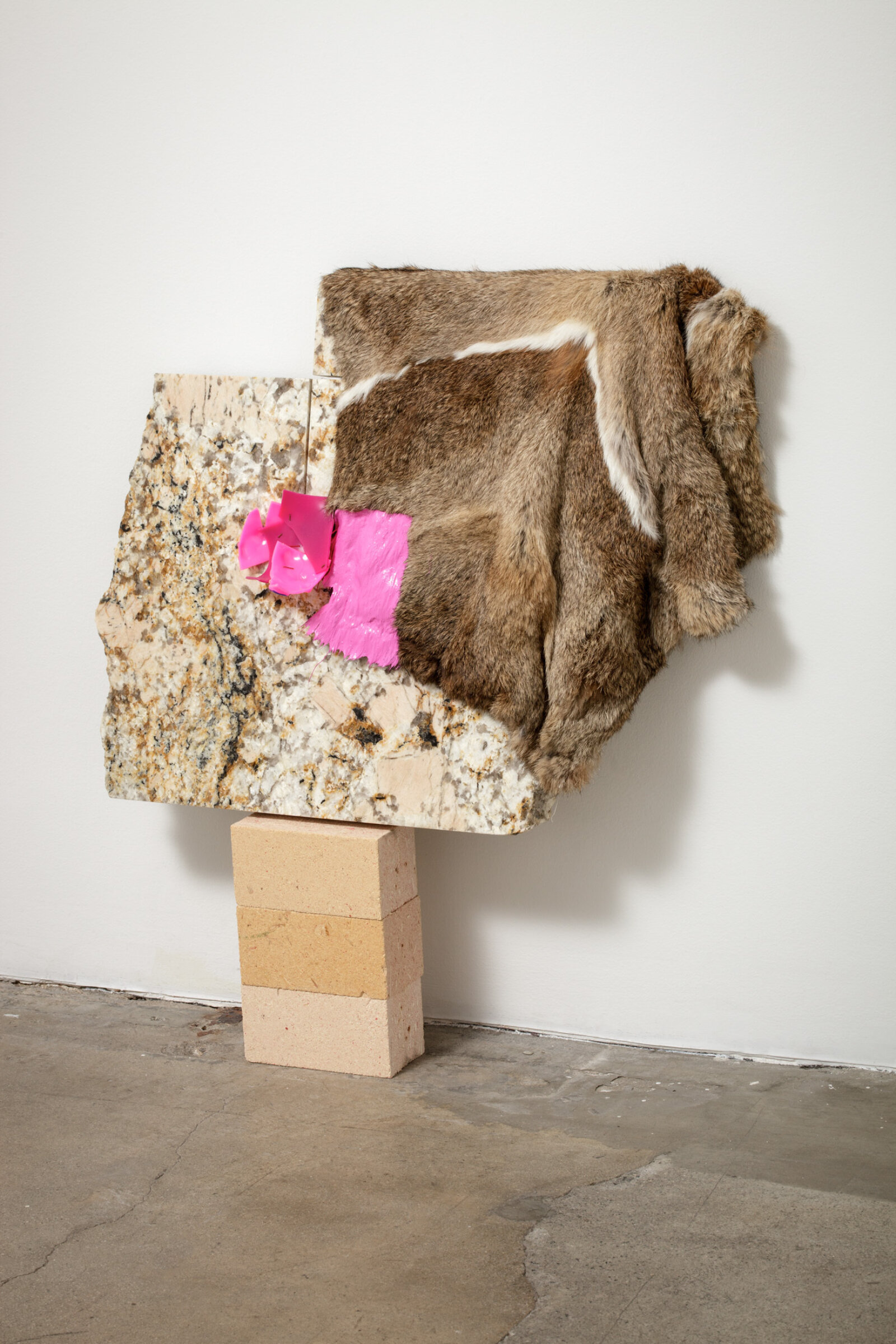 Jessica Stockholder, Related, 2013, fur, plastic parts, wood fibre blocks, granite, acrylic paint, 29 x 27 x 5 in. (72 x 69 x 13 cm)
