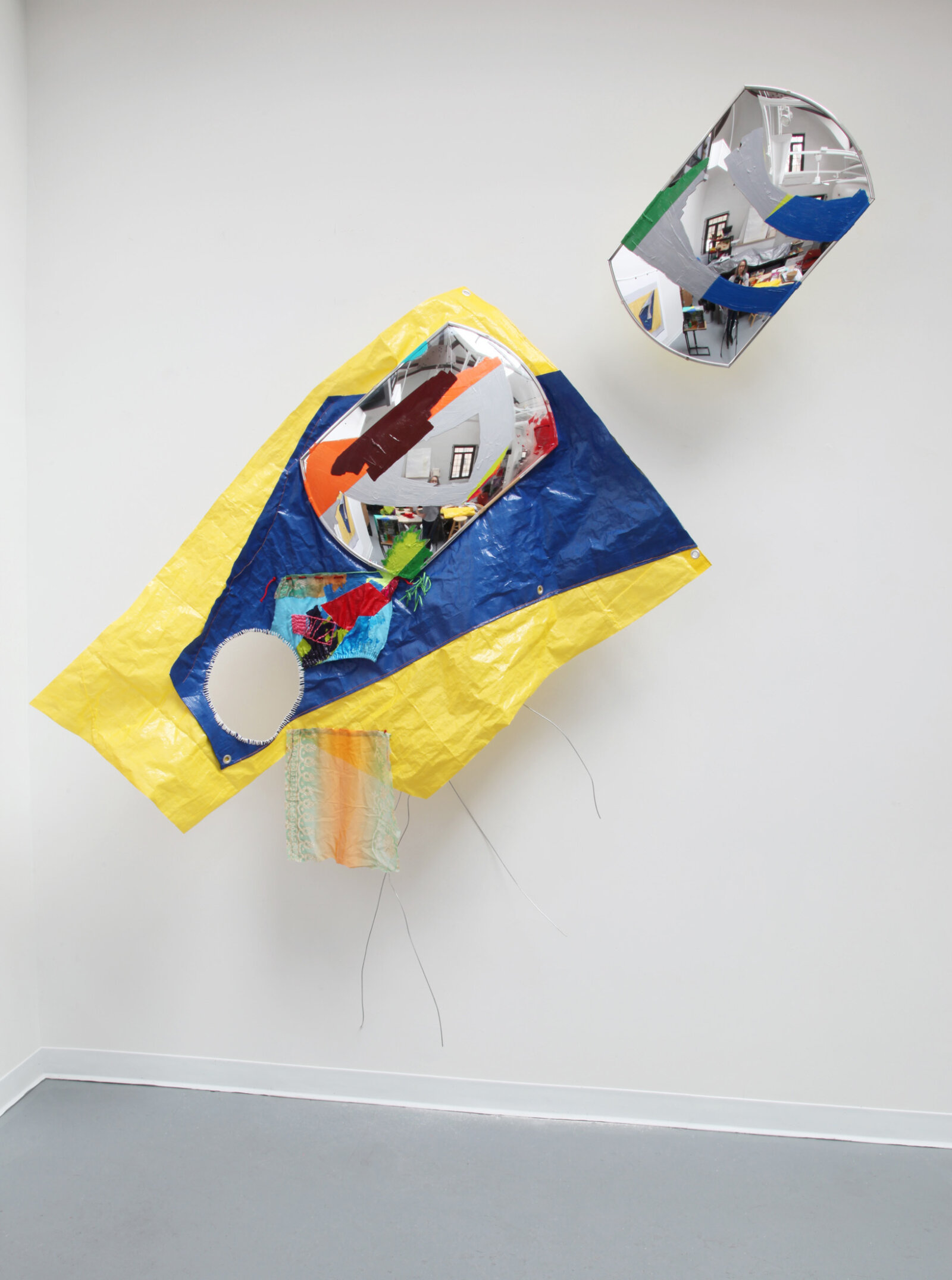Jessica Stockholder, Repair, 2019, 2 driveway mirrors, plastic tarp, fabric, hardware, wire, rope, string, thread, wire, acrylic and oil paint, 109 x 83 x 19 in. (277 x 211 x 48 cm)