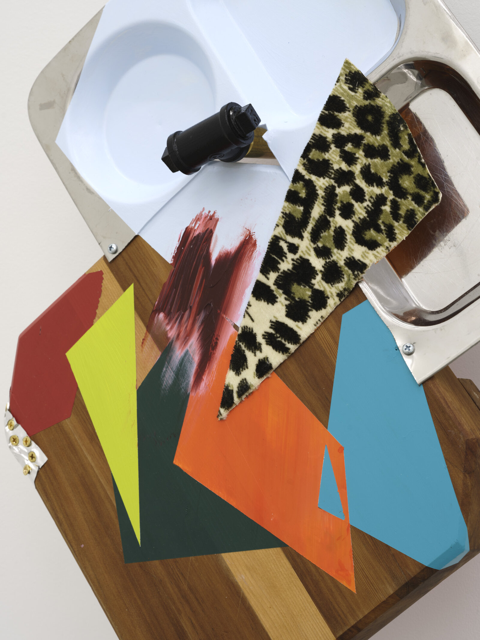 Jessica Stockholder, That soft patch behind the knee poked by the snow covered peak (detail), 2025, wooden chopping board, metal tray, acrylic paint, oil paint, fabric, caulking, foil, cable, hardware, 47 x 16 x 7 in. (118 x 41 x 18 cm)