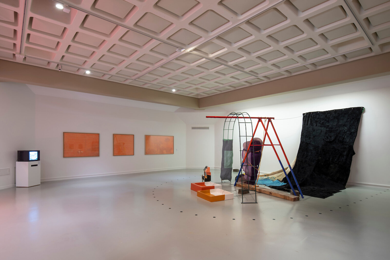Jessica Stockholder, Torque, Jelly Role, and Goose Bump, 1997, paper maché, heater, 2 shower trays, acrylic and enamel paint, fur, sofa, swing, 120 x 239 x 232 in. (305 x 608 x 590 cm)