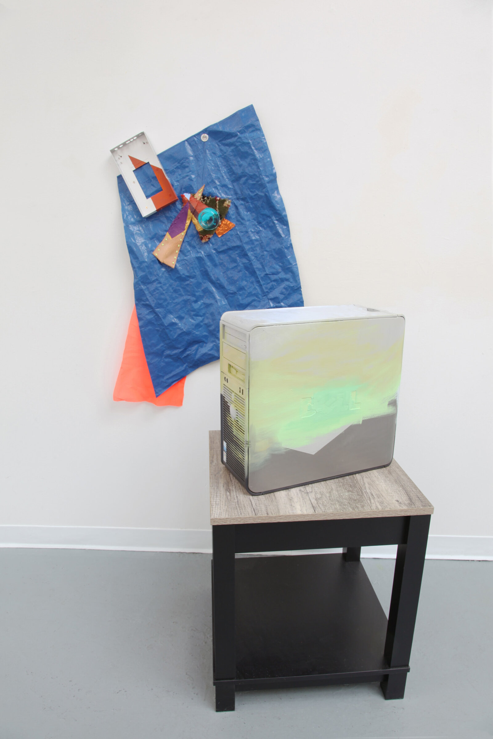 Jessica Stockholder, Trek, 2018–2020, oil paint on computer, plastic tarp, leather, thread, plastic cup fragment, hard drive, metal foil, carpet, string, plastic mesh, acrylic paint, 41 x 30 x 30 in. (104 x 76 x 76 cm)