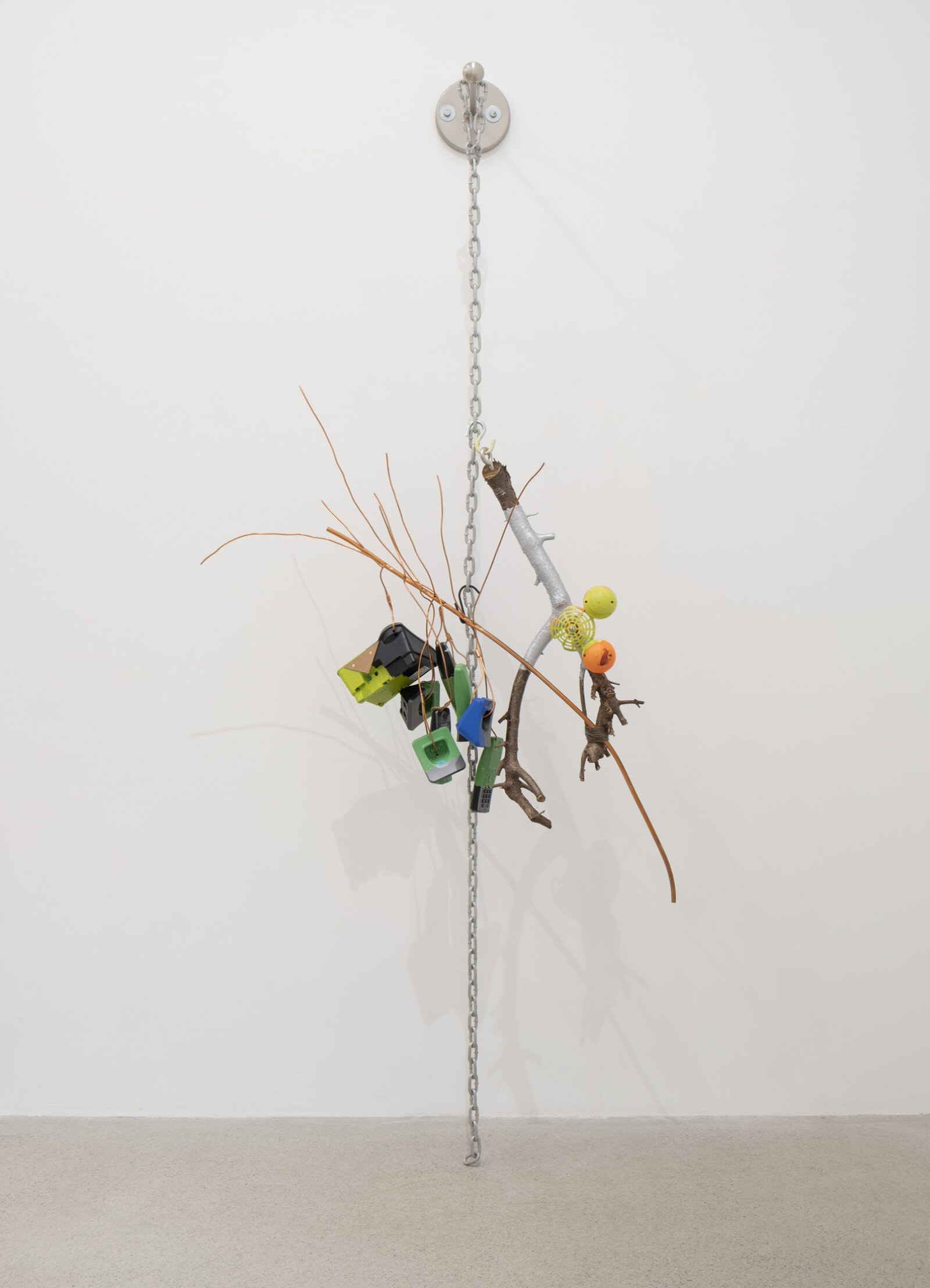 Jessica Stockholder, JS530, 2012, branches, phones, plastic, chain, copper tubing, yarn, acrylic paint, linoleum, hardware, 89 x 37 x 17 in. (226 x 94 x 43 cm)
