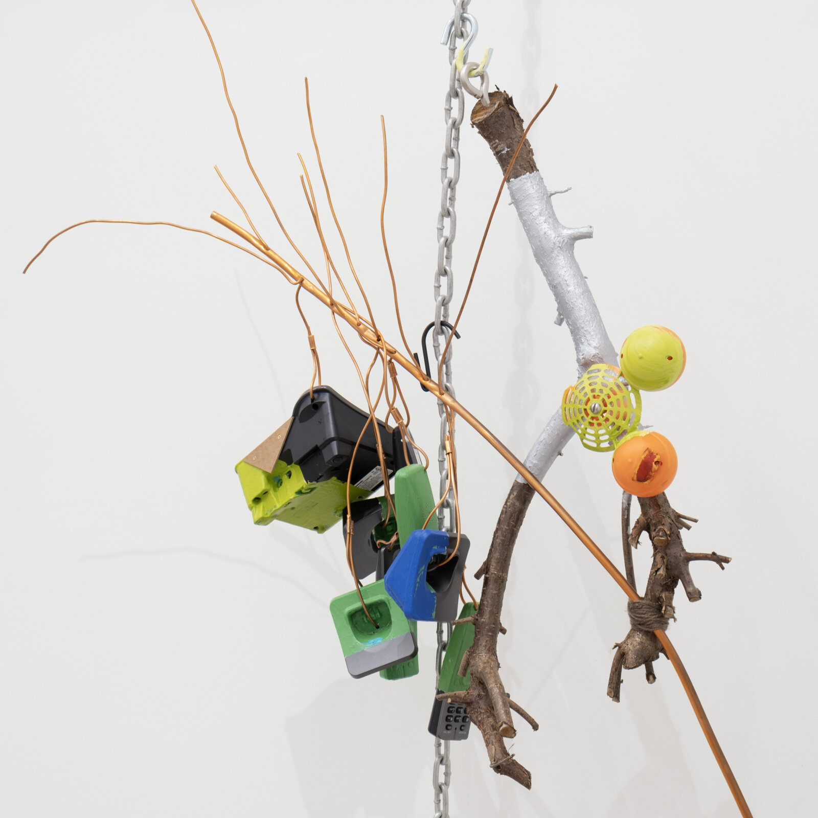 Jessica Stockholder, JS530 (detail), 2012, branches, phones, plastic, chain, copper tubing, yarn, acrylic paint, linoleum, hardware, 89 x 37 x 17 in. (226 x 94 x 43 cm)