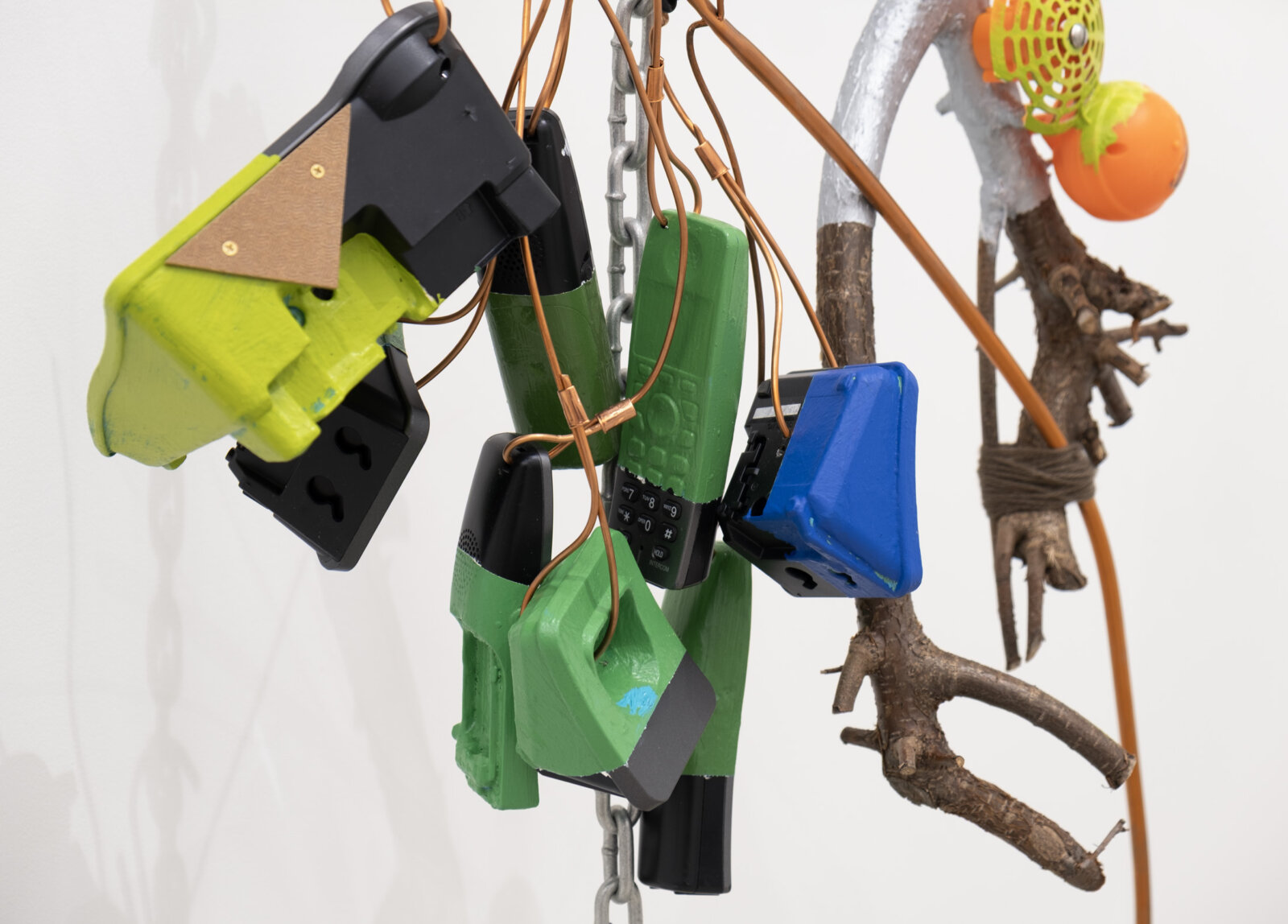Jessica Stockholder, JS530 (detail), 2012, branches, phones, plastic, chain, copper tubing, yarn, acrylic paint, linoleum, hardware, 89 x 37 x 17 in. (226 x 94 x 43 cm)