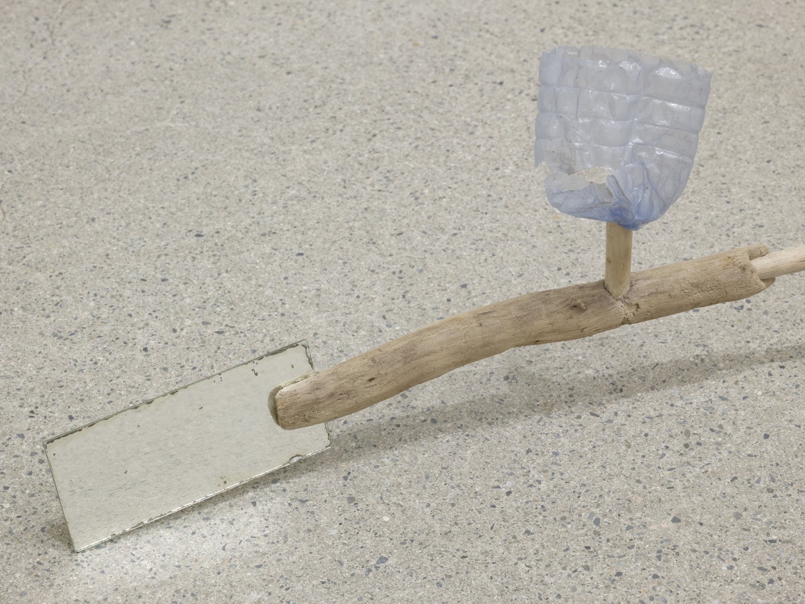 ​Ashes Withyman, Under a mouldy sky (spent tire, slab of stone, torn barbed wire fence) (detail), 2019, branches, margarine container base, penny, portion of water bottle, mirror, 7 x 26 x 4 in. (18 x 66 x 10 cm) by Ashes Withyman