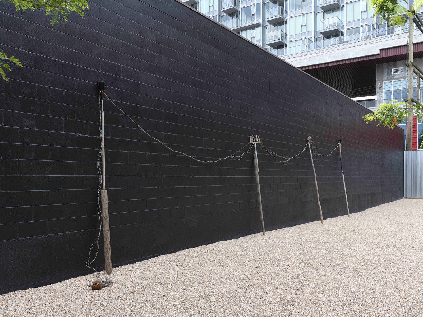 Ashes Withyman, Electrical poles from a place, near the buried canal, 2011–2012, wire, steel, wood, glass bottles, dimensions variable